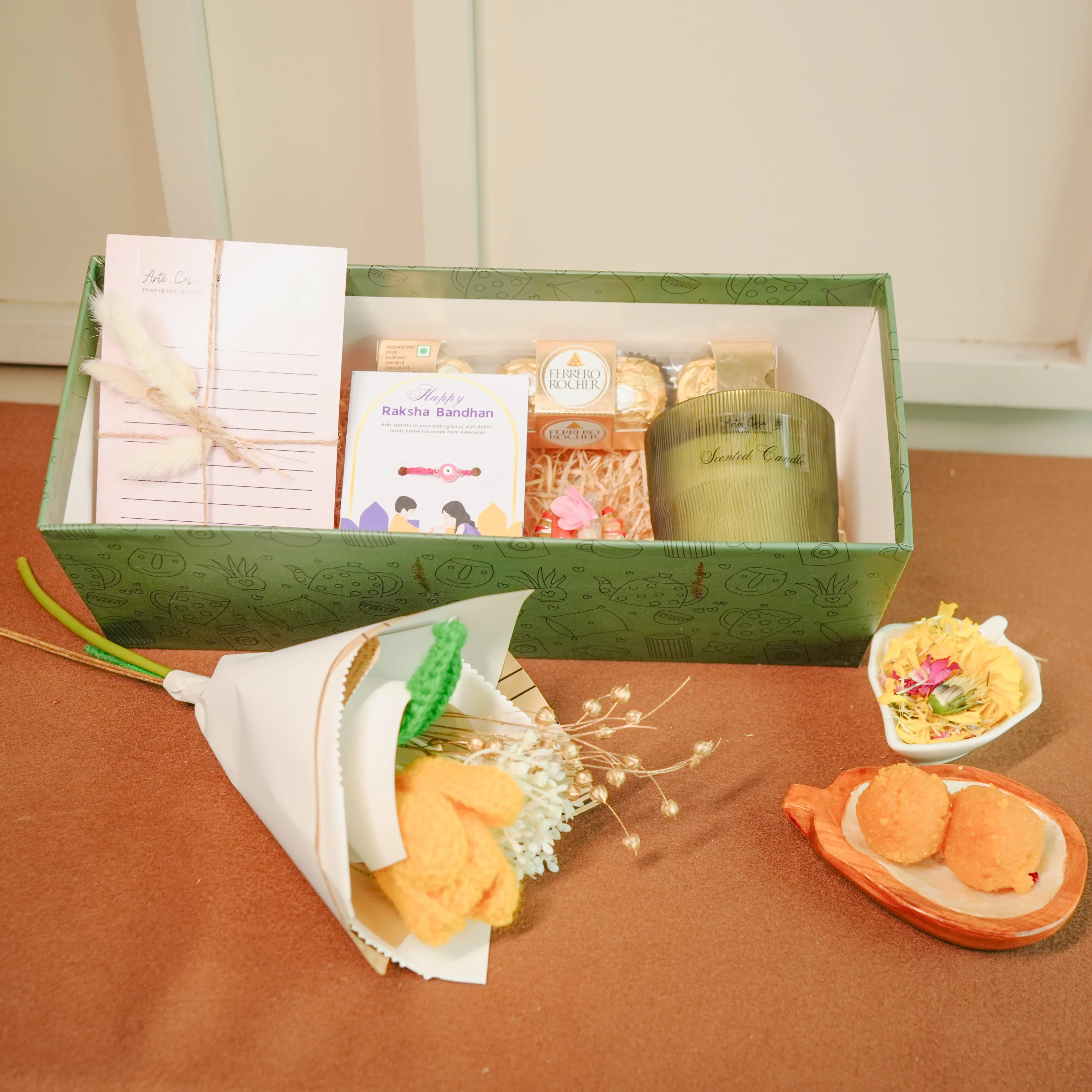 Flower-Themed Rakhi Hamper for Bhai & Bhabhi | Thoughtful Rakhi Gift Set with Candle, Chocolates & Flower Bunch