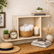 Rustic wooden wall shelf used for home decor styling, featuring rolled white towels in a woven basket, a lit candle, green plants and minimal accessories ideal for modern Indian interiors