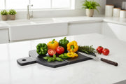 Black marble chopping board in kitchen with fresh vegetables