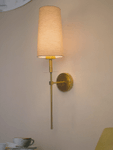 Savoy Long Arm Antique Gold Wall Sconce with Beige Fabric Shade.