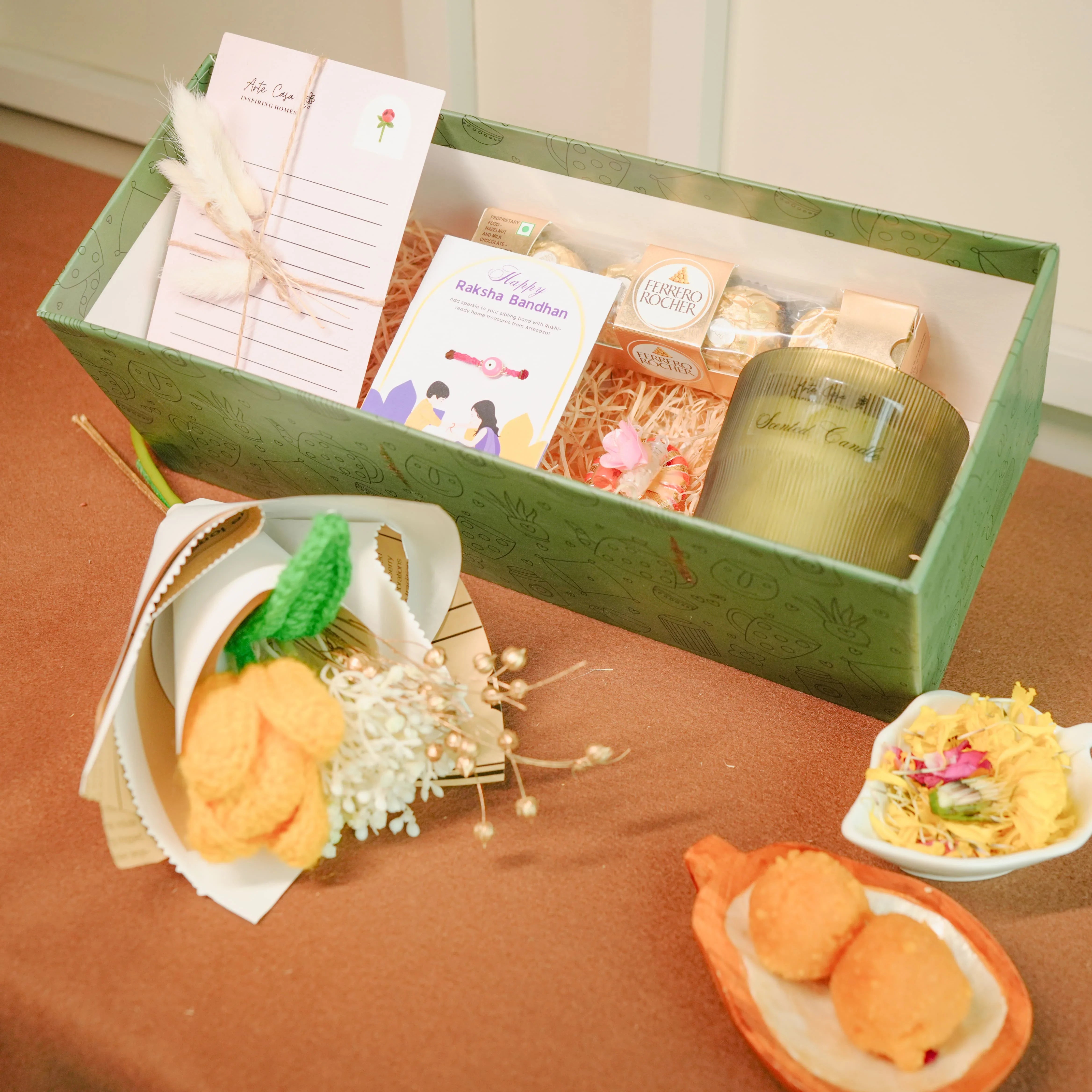 Flower-Themed Rakhi Hamper for Bhai & Bhabhi | Thoughtful Rakhi Gift Set with Candle, Chocolates & Flower Bunch