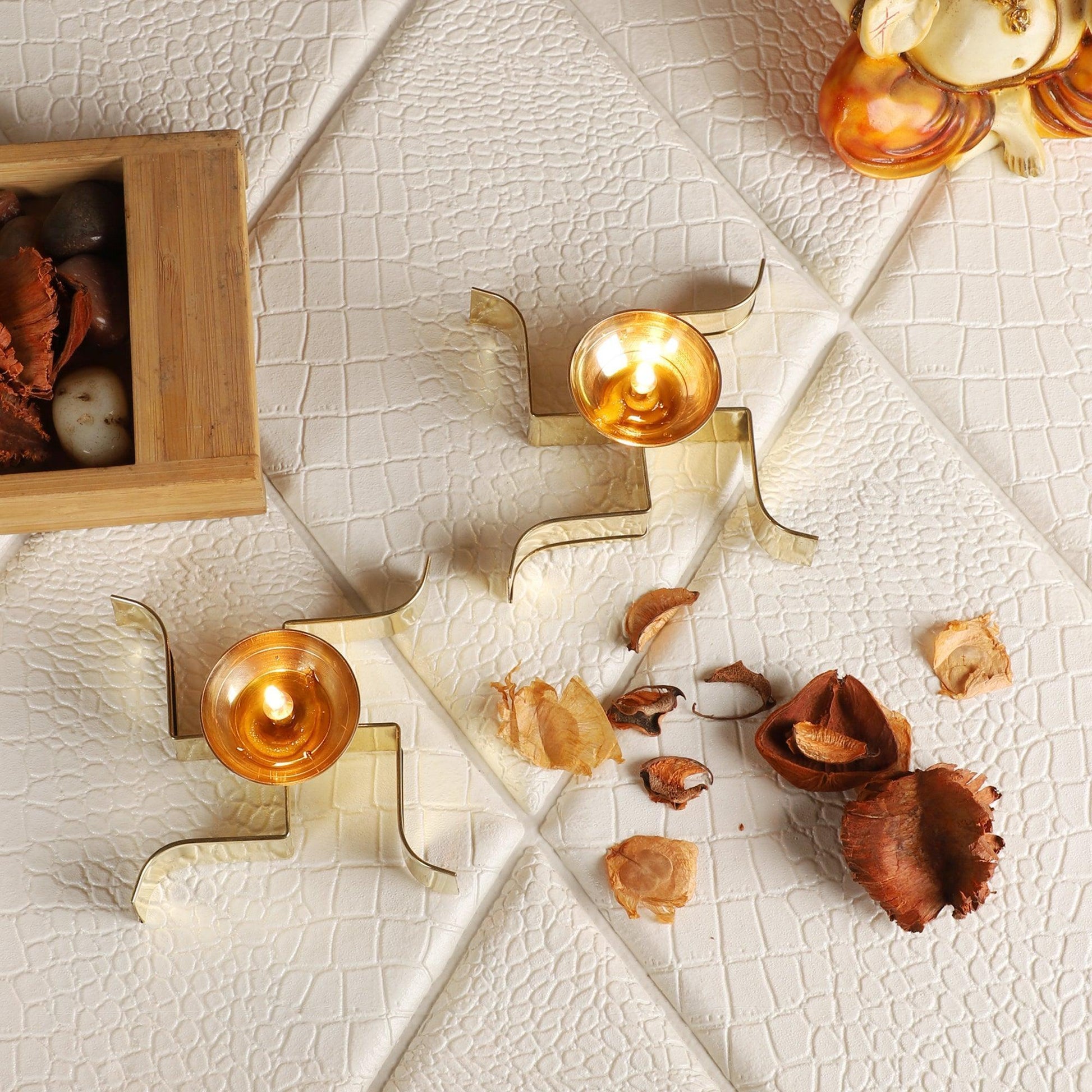 Buy Diya & Diya Stand - Golden Sleeping Satiya Diya Set Of 2 | Brass Swastik Tealight Holder by Amaya Decors on IKIRU online store