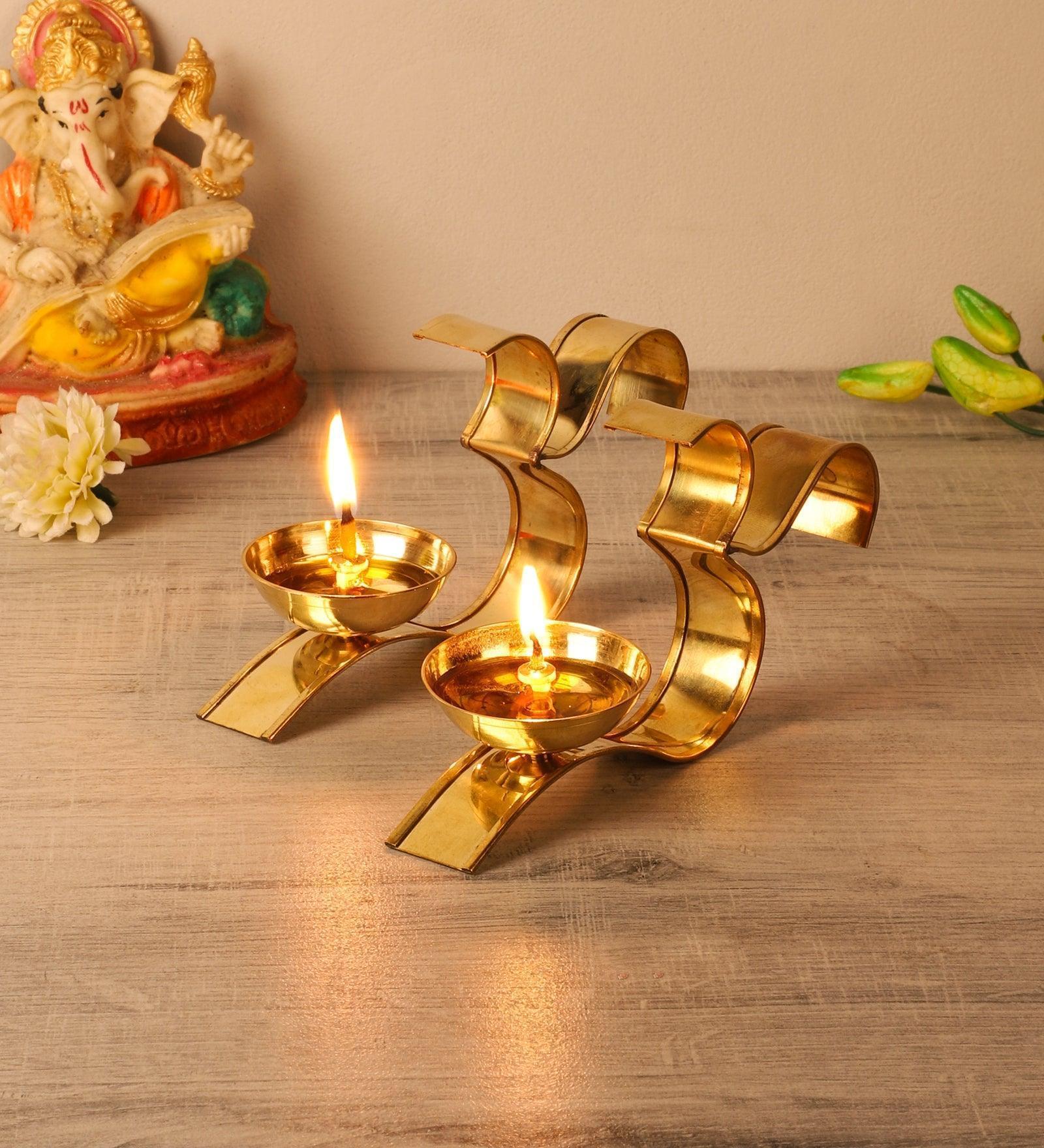 Buy Diya & Diya Stand - Om Golden Akhand Diya Set Of 2 | Brass Tealight Holder Stand by Amaya Decors on IKIRU online store