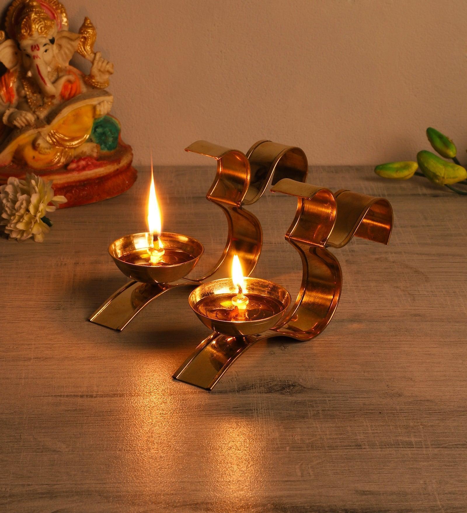 Buy Diya & Diya Stand - Om Golden Akhand Diya Set Of 2 | Brass Tealight Holder Stand by Amaya Decors on IKIRU online store