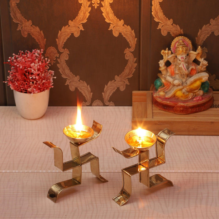 Buy Puja Essentials - Golden Standing Satiya Diya Set Of 2 | Brass Swastik Tealight Holder by Amaya Decors on IKIRU online store